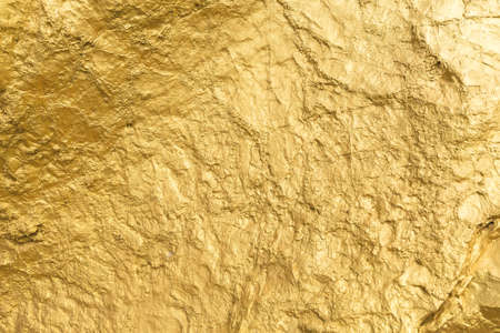 Gold paint stone or rock texture glitter abstract on background.の写真素材