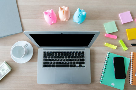 Modern office desk table with laptop, smartphone and other supplies with cup of coffee. Top view, flat lay.の写真素材