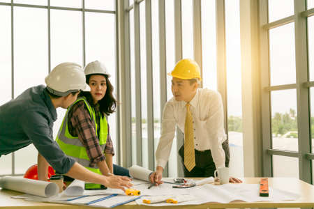 Engineer people meeting working and pointing at a drawings in office for discussing.の写真素材
