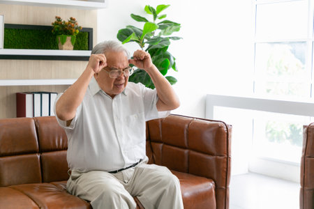 Senior man having a headache hands on forehead. Medical and healthcare concept