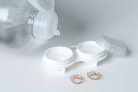 Finger with contact lens on blurred background.の写真素材