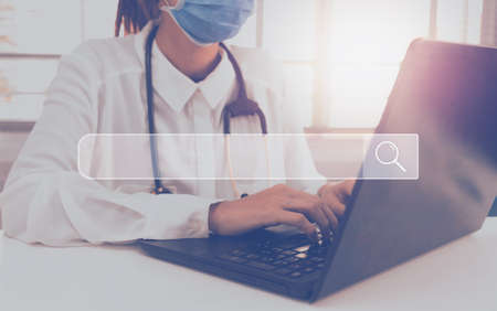 Doctor holding heart in her hands of medical network world connection with modern virtual screen interface.の写真素材