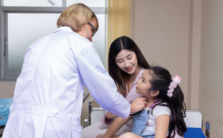 Doctor measures the pressure of the patient during a medical examination and discuss in the...