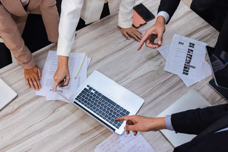 Green plant in small modern terracotta pot on white wood shelf isolated on white wall background.の写真素材