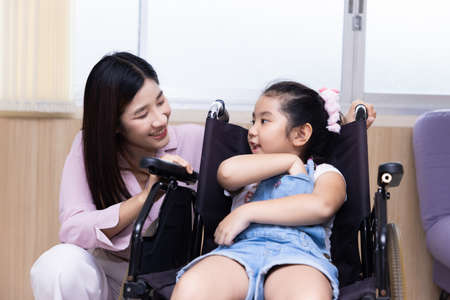 Portrait of Asian cute little girl looking and resting on his mother's in the patient room in hospital. Healthcare medical and people concept.の写真素材