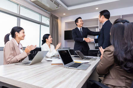 Business executives congratulate employees on their excellent work. Welcome to our team.の写真素材