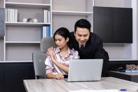 A Boss touching the shoulder of employee colleague in workplace at office.の写真素材