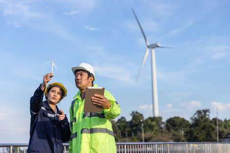 Young female engineer smiling and holding harthat looking to the future.