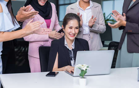 Business people congratulating, applauding employees and cheering, standing in office.