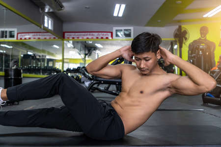 Handsome muscular man posing and flexing muscles.