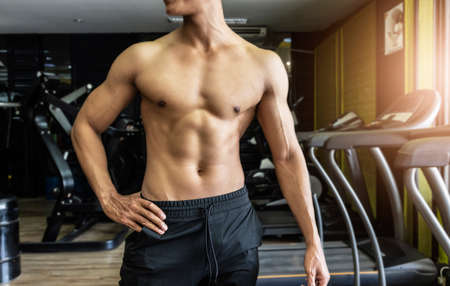 Handsome muscular man posing and flexing muscles.の写真素材