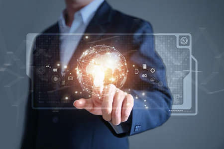 Businessman holding digital datas with world interface with finger.の写真素材