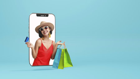 Portrait of beautiful asian girl wearing dress and sunglasses holding shopping bags isolated over blue background.の写真素材