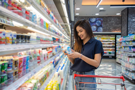 Asian beautiful woman shopping foods or beverages at supermarket.の写真素材