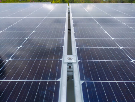 Solar panels installed on a roof of a large industrial building or a warehouse.の写真素材