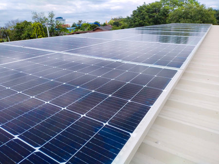 Solar panels installed on a roof of a large industrial building or a warehouse.の写真素材