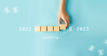 Hand putting wooden cube for countdown to 2022. Loading year from 2022 to 2023. New year start conceptの写真素材