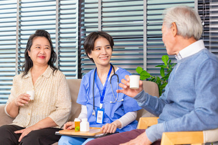 Female nurse giving senior man medical pills.の写真素材