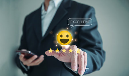 Businessman finger touching on the happy Smiley face icon and five star to give satisfaction in service. Customer service and Satisfaction conceptの写真素材