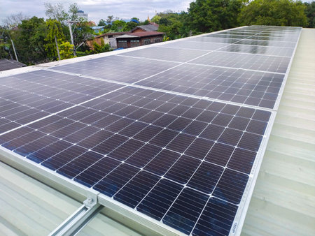 Solar panels installed on a roof of a large industrial building or a warehouse.の写真素材