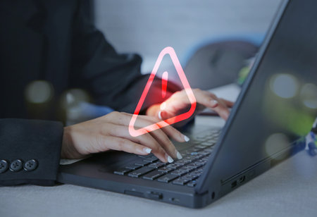 Businesswoman using computer laptop with caution warning sign for notification error concept.