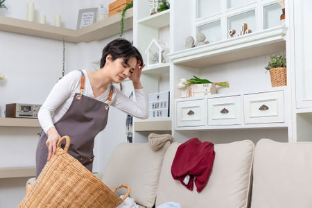 Happy Asian cleaner woman with laundry working at home.の写真素材