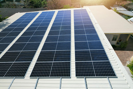 Solar panels installed on a roof of a large industrial building or a warehouse.の写真素材