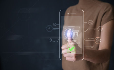 Businessman thumb login with fingerprint scanning on smartphone. fingerprint to identify personal, security system conceptの写真素材