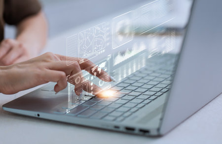 Finger press analyst on a laptop showing statistics, Graphs and Charts.の写真素材