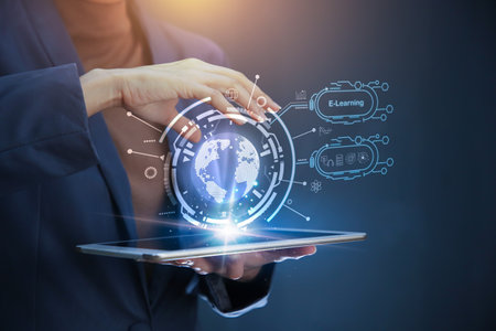 Businessman hand holding tablet on Holographic world globe over black background. E-learning online conceptの写真素材