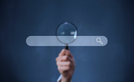 A business man holding magnifier and touch searching bar, technology and internet online concept.の写真素材