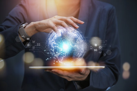 Businessman holding in hand tablet with global connection in 3D rendering out of digital tablet on blue background.の写真素材
