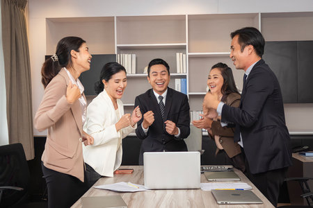 Business man and woman work together, celebrate success in start up office. Creative team brainstorm meeting, businesspeople colleague partnership conceptの写真素材