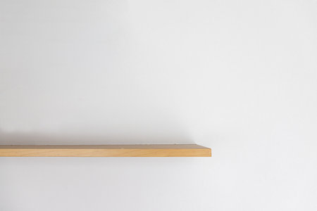 Empty wooden wall shelf on white background.の写真素材