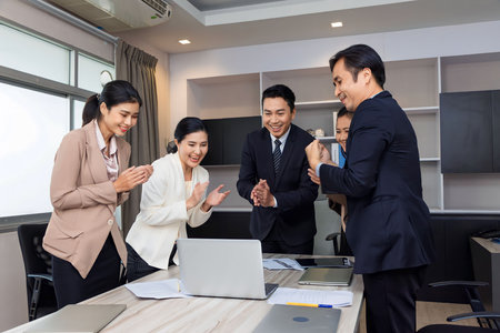 Business man and woman work together, celebrate success in start up office. Creative team brainstorm meeting, businesspeople colleague partnership conceptの写真素材