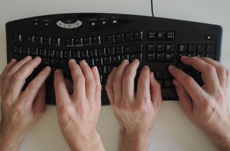 The activity "Pair programming" in extreme programming and scrum illustrated by two pair of hands on the keyboard.の写真素材