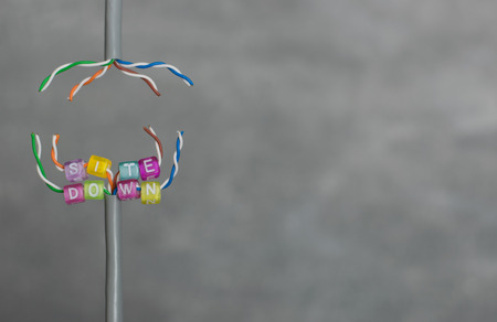 Text in colorful pearls. Site down for website maintenance with grey background and room for writing...