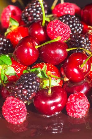 Black chocolate pie with strawberries raspberries cherriesの写真素材