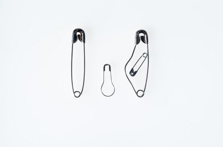 A family rapresented with safety pins, pregnant mother father and sonの写真素材