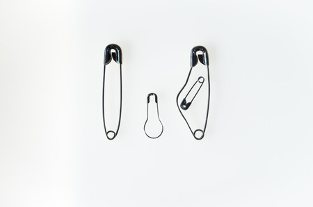 A family rapresented with safety pins, pregnant mother father and sonの写真素材