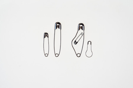 A family rapresented with safety pins, pregnant mother father and two sonsの写真素材