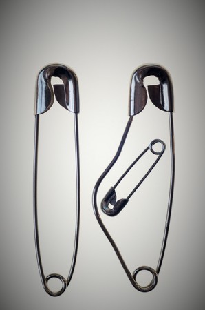 A family rapresented with safety pins, pregnant mother and fatherの写真素材