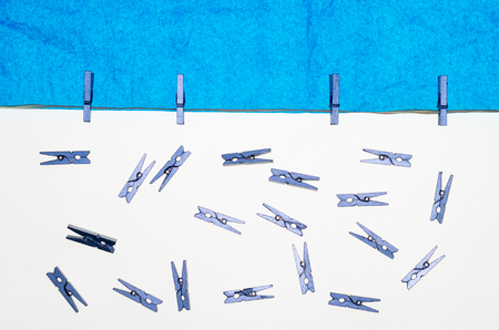 composition with blue sky made with tissue paper, a rope, and many small pegs for hanging the laundryの写真素材