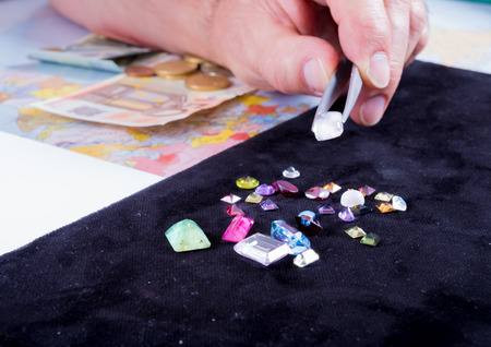 Customer and seller negotiate the purchase of a batch of precious stones calculating the current valueの写真素材