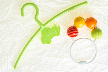 colored hanger, coat rack for infants clothing and a colorful rattle toyの写真素材