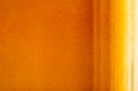 roll of paper for graphic use textured with parallel lines with warm color shades of orangeの写真素材