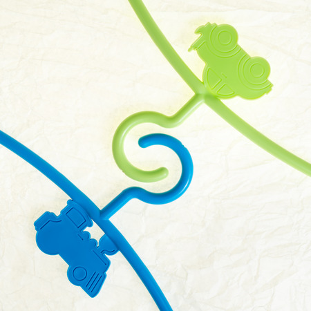 colored hanger, coat rack for infants clothing as a colorful  toyの写真素材
