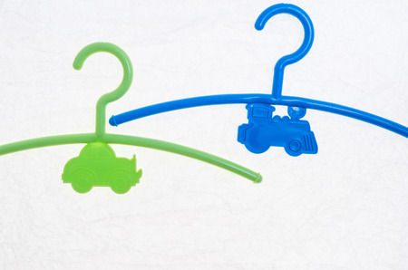 colored hanger, coat rack for infants clothing and a colorful rattle toyの写真素材