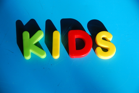 Spelling kids with toy lettersの写真素材