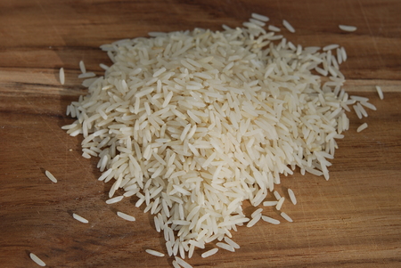 Rice on a wooden breadboardの写真素材